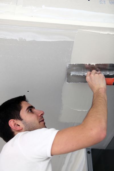 Replacing drywall panels after water damage in a Palm Beach house